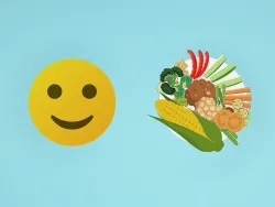 Lachender Smiley und Teller mit Gemüse und Obst vor blauem Hintergrund