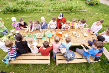 Kinder jausnen Brot, Salat und Aufstriche im Grünen