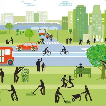 Stadt mit Hochhäusern, großer Grünfläche im Vordergrund, Autos und Bussen 